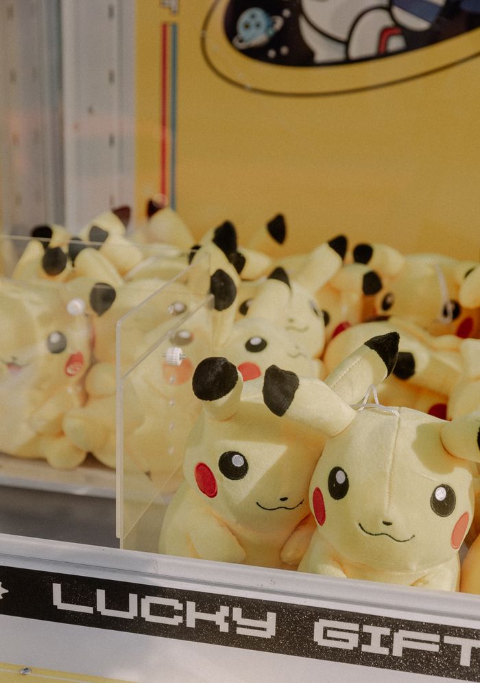 A claw machine filled with Pikachu plush toys, creating a nostalgic arcade atmosphere.